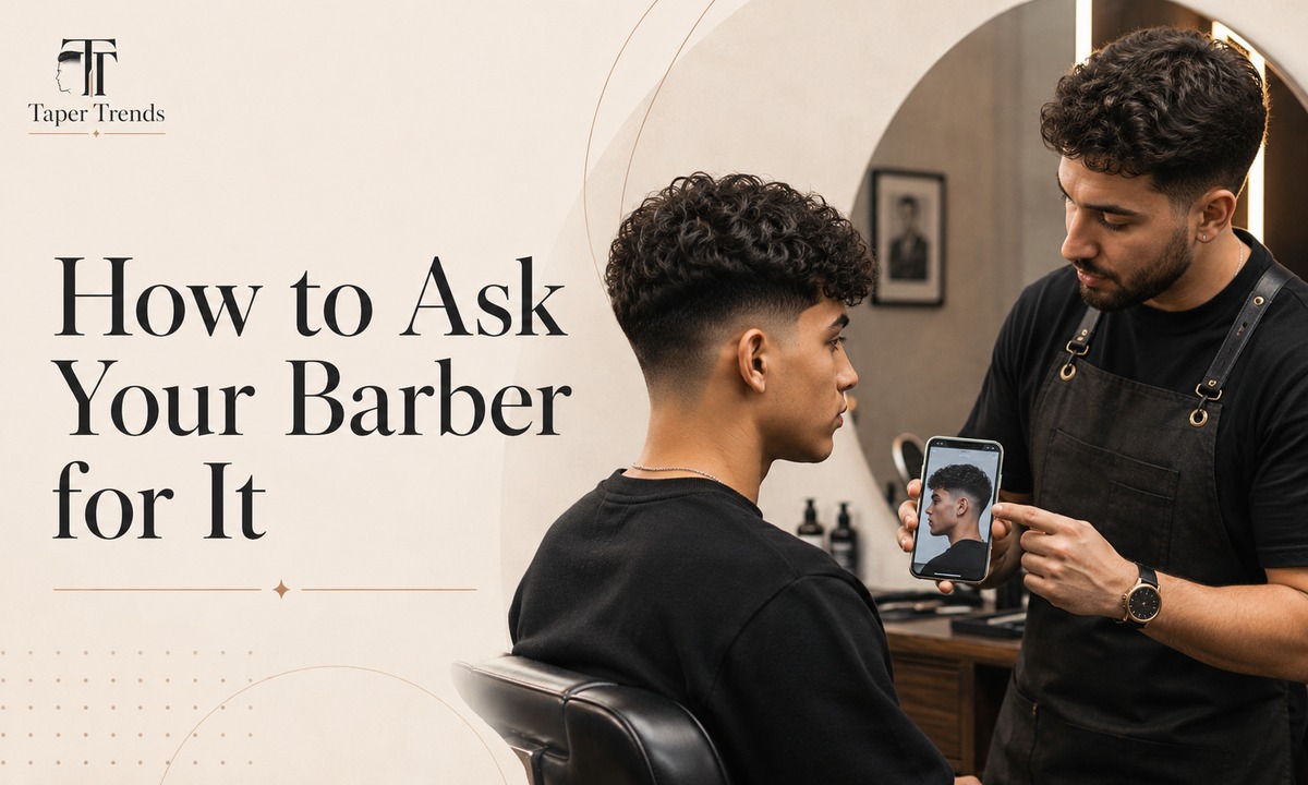 A barber cutting a taper low burst fade, curving the fade around the ear rather than in a straight line.